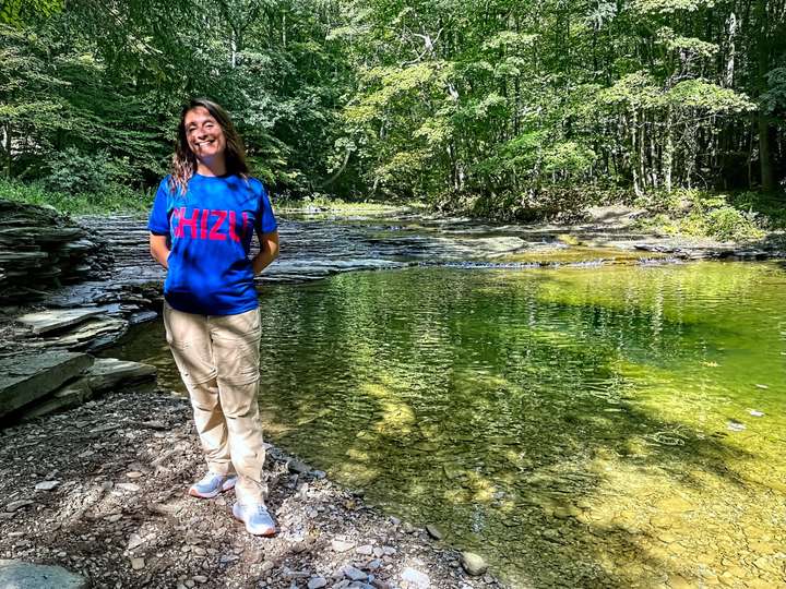 Maria stands next to Six Mile Creek while wearing her Chizu shirt in Harborcreek, PA, US