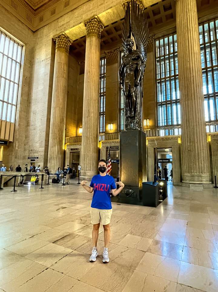 Maria stands next to a memorial statue at the Amtrak station while wearing her Chizu shirt in Philadelphia, PA, US