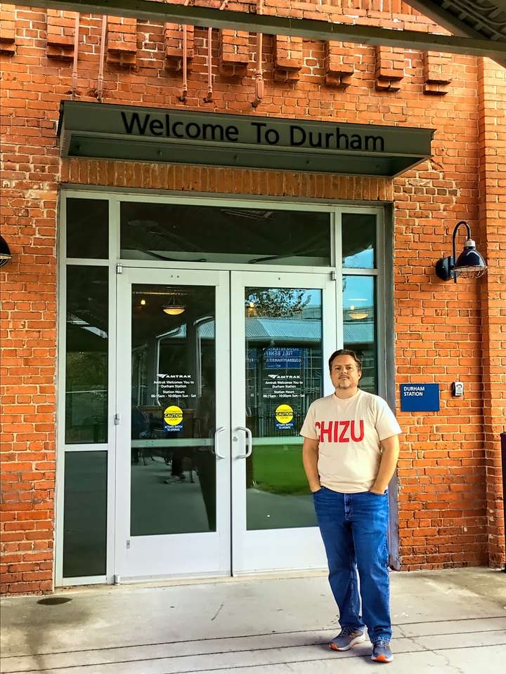 Neil stands outside the train station while wearing his Chizu shirt in Durham, NC, US