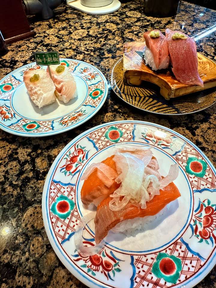 Three plates of sushi on our table